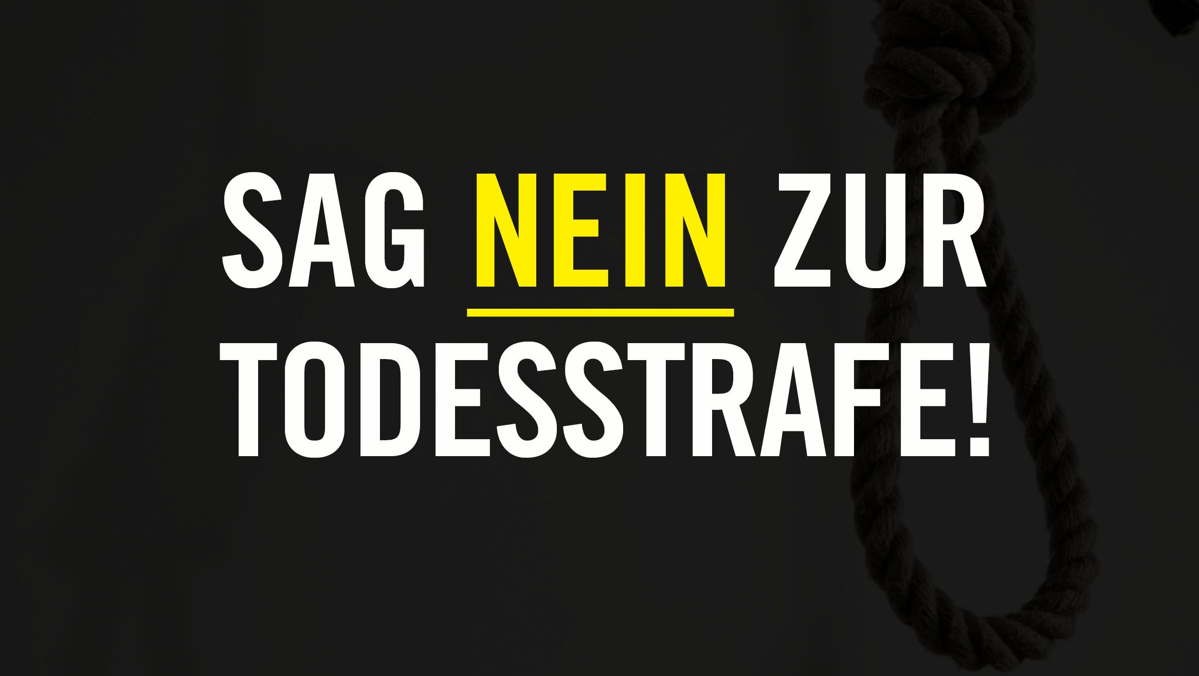 Eine schwarze Tafel, auf der in Weiss und Gelb geschrieben steht: "Sag nein zur Todesstrafe!"