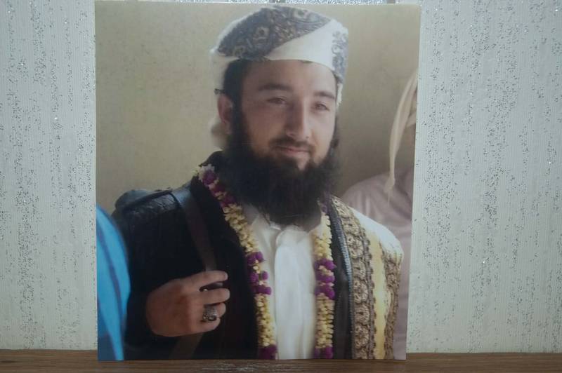 Ein junger Mann lächelt und trägt traditionelle Kleidung