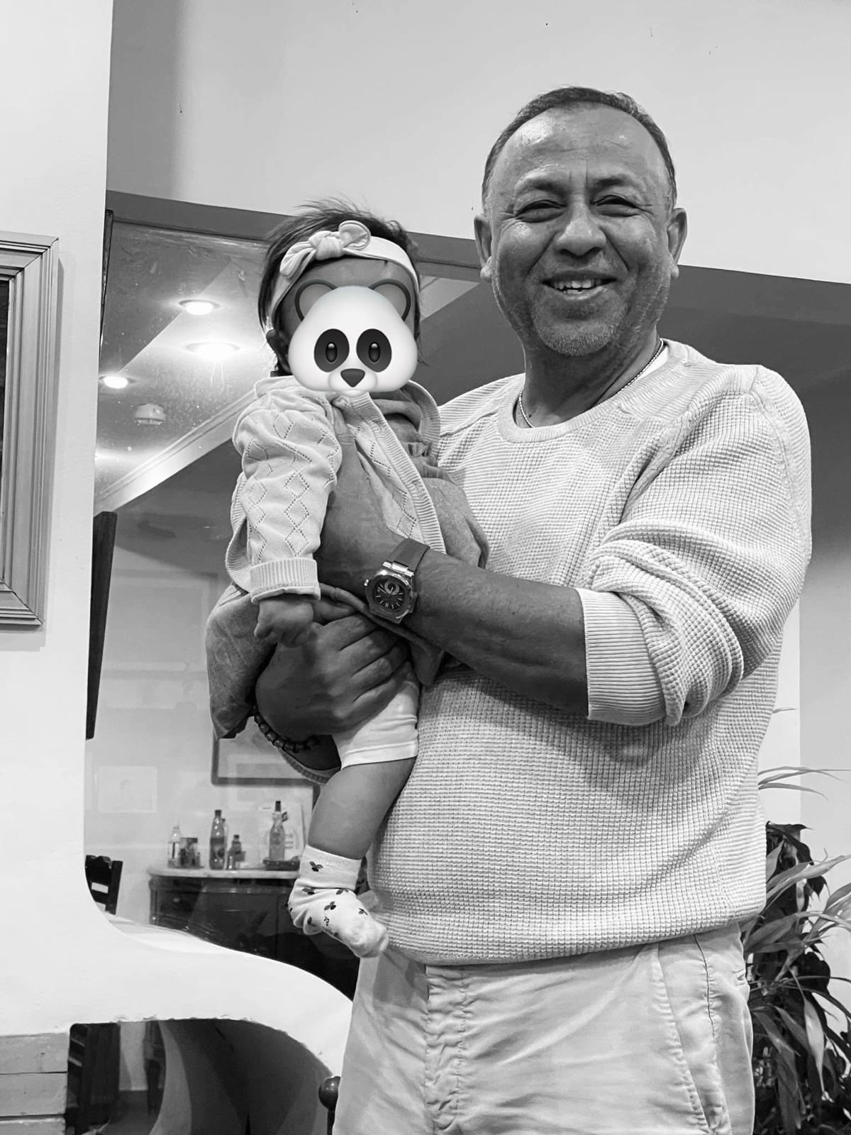 Das Foto zeigt Sylvain Rabetsaroana, der ein kleines Kind auf dem Arm trägt. Er lächelt in die Kamera. Das Foto wurde digital bearbeitet, um das Gesicht des Kindes unkenntlich zu machen. Auf dem Gesicht wurde ein Panda-Gesicht digital platziert.