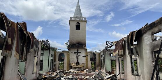 Das Foto zeigt die bis auf die Grundmauern niedergebrannte Ruine einer Kirche.