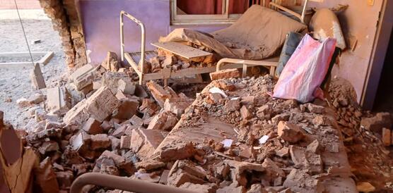 Zerstörtes Krankenhauszimmer in der sudanesischen Stadt Al-Faschir nach einem Luftangriff. Auf den Betten liegen Trümmer. Links in der Wand klafft ein großes Loch.