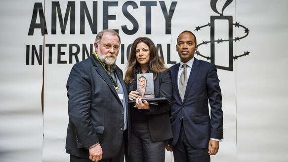 Rolf Opalka, Alice Brauner und Markus Beeko vor dem Amnesty-Logo