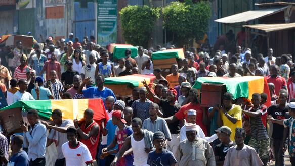 Menschen tragen am 4.11.2019 Särge durch Conakry. Darin sind die bei den Protesten gegen die Verfassungsänderunge Getöteten
