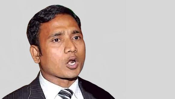 Porträtfoto von Shahnewaz Chowdhury, der einen Anzug und Krawatte trägt.