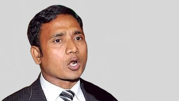 Porträtfoto von Shahnewaz Chowdhury, der einen Anzug und Krawatte trägt.